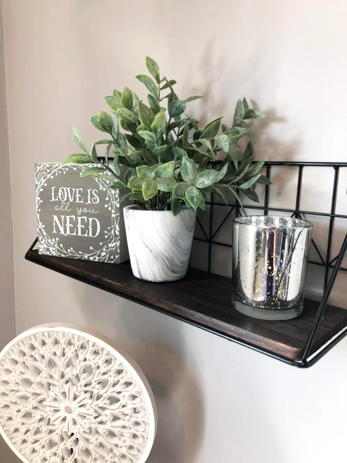 An 11-inch floating shelf carrying a pot and a candle