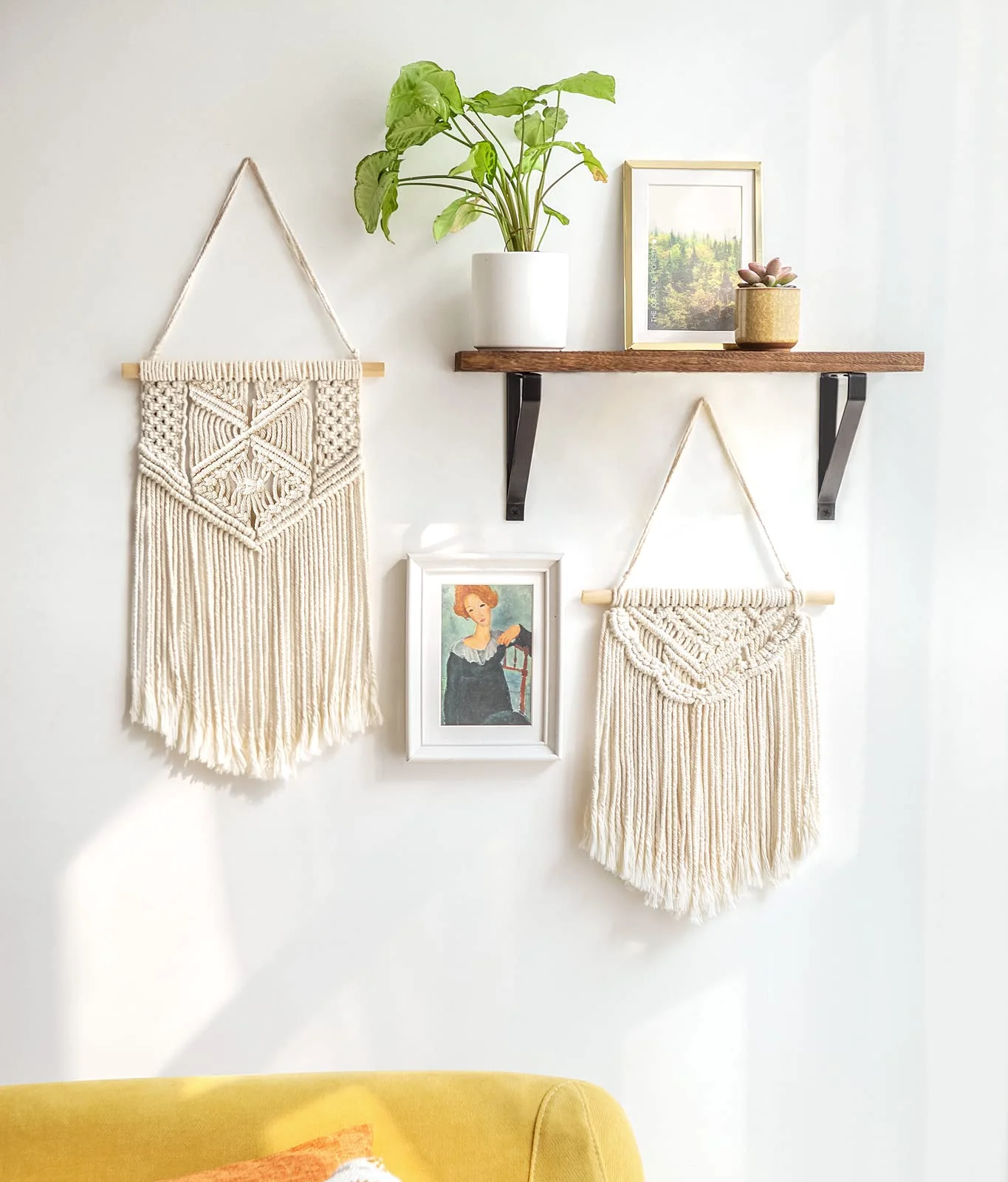 Wall hangings beside a shelf of frames