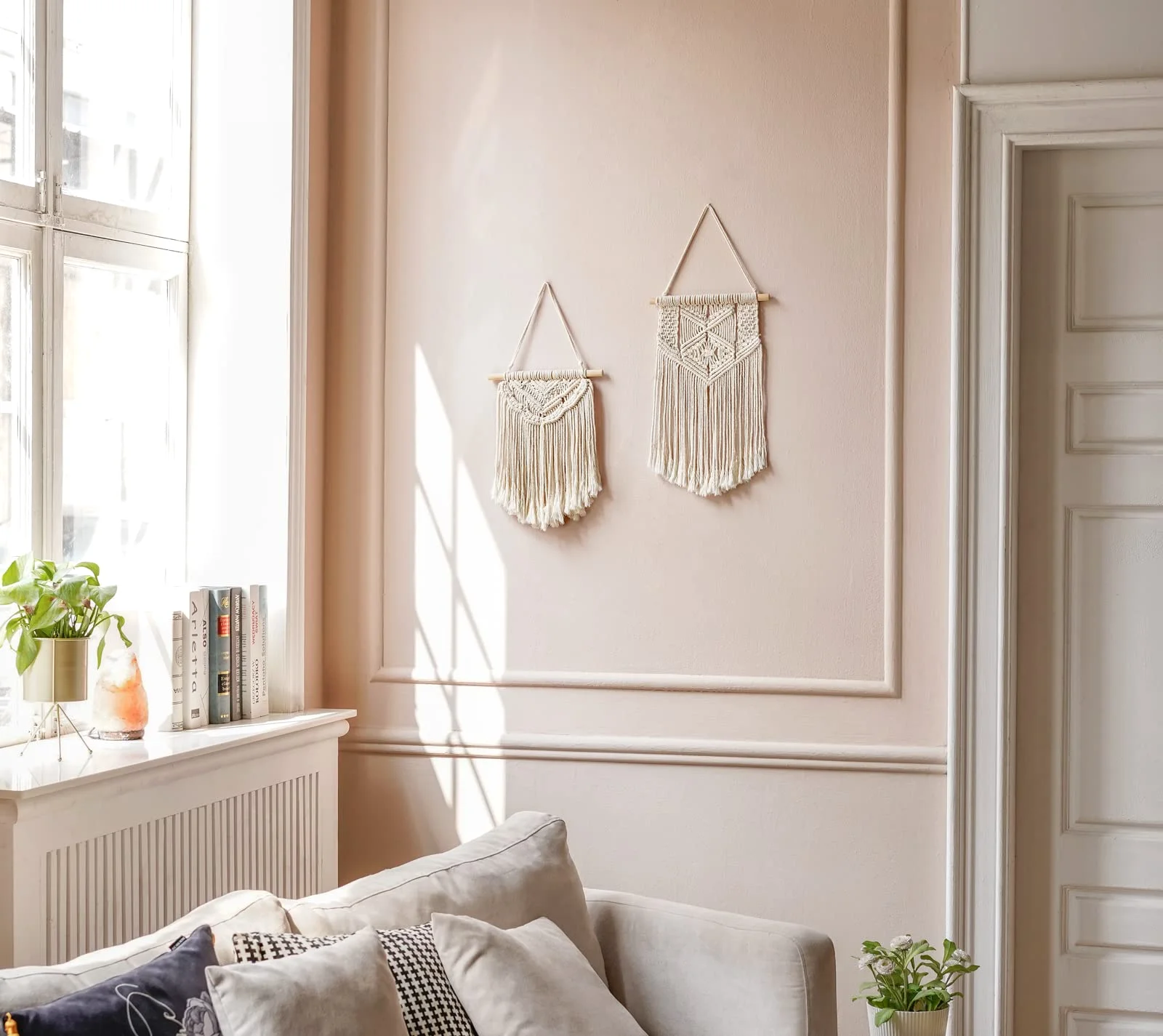 Two 13-inch wall hangings on a plain plaster wall